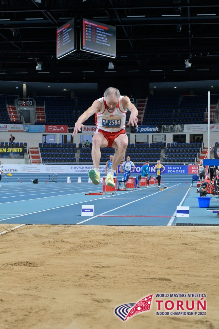 Marek Grzyb, M65, POL,competing in long jump.